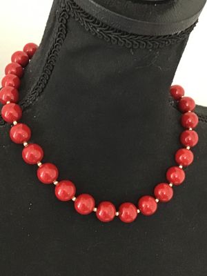 Sale Photo Thumbnail #27: A classic strand necklace featuring vibrant glossy red round beads separated by small gold-tone spacer beads. Features a traditional gold-tone hook and end bead clasp closure. Appears to be in good vintage condition with minimal surface wear. Please revie