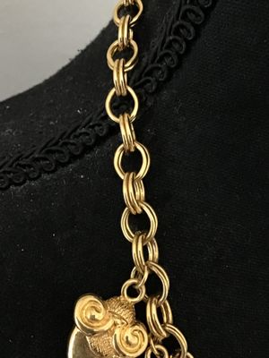 Sale Photo Thumbnail #35: A vintage gold-tone chain necklace by Kenneth Jay Lane (marked © KJL on hangtag). Features a double link chain adorned with detailed acorn-shaped drop charms and faux pearl clusters. Includes an adjustable extender chain with a pearl end drop. Overall go