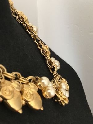 Sale Photo Thumbnail #34: A vintage gold-tone chain necklace by Kenneth Jay Lane (marked © KJL on hangtag). Features a double link chain adorned with detailed acorn-shaped drop charms and faux pearl clusters. Includes an adjustable extender chain with a pearl end drop. Overall go