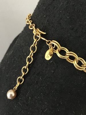 Sale Photo Thumbnail #33: A vintage gold-tone chain necklace by Kenneth Jay Lane (marked © KJL on hangtag). Features a double link chain adorned with detailed acorn-shaped drop charms and faux pearl clusters. Includes an adjustable extender chain with a pearl end drop. Overall go