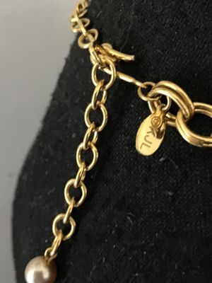 Sale Photo Thumbnail #36: A vintage gold-tone chain necklace by Kenneth Jay Lane (marked © KJL on hangtag). Features a double link chain adorned with detailed acorn-shaped drop charms and faux pearl clusters. Includes an adjustable extender chain with a pearl end drop. Overall go