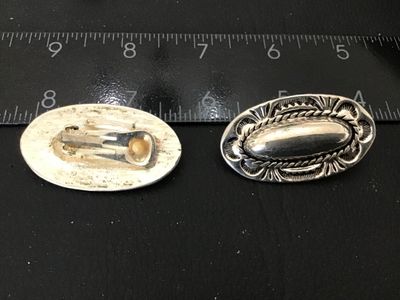 Sale Photo Thumbnail #67: Pair of oval silver-tone clip-on earrings featuring Southwestern style stamped detailed borders, rope trim accents, and raised central domes. Each earring measures approximately 1.25 inches in length. Clip backs are intact and functional. Excellent pre-ow