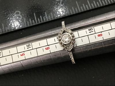 Sale Photo Thumbnail #98: Silver-tone band ring featuring a central evil eye design set with clear round crystals and crystal accents along the shoulders. Inside band exhibits maker's hallmarks. Measured on ring mandrel as approximately size 6. Pre-owned condition with light wear.