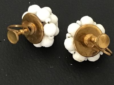 Sale Photo Thumbnail #104: Pair of vintage mid-century cluster screw-back earrings featuring opaque white glass beads on gold-tone metal backings. Stamped 'WEST GERMANY' on the screw hardware. In good vintage condition with minor surface age appropriate wear to metal backs.