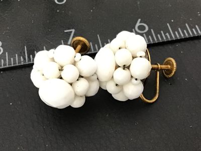 Sale Photo Thumbnail #103: Pair of vintage mid-century cluster screw-back earrings featuring opaque white glass beads on gold-tone metal backings. Stamped 'WEST GERMANY' on the screw hardware. In good vintage condition with minor surface age appropriate wear to metal backs.