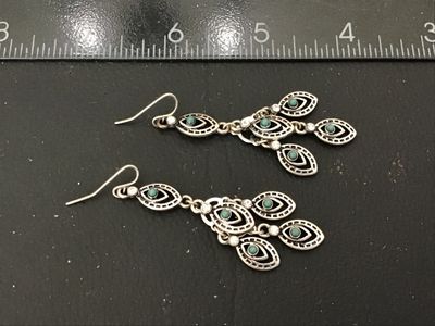 Sale Photo Thumbnail #124: Pair of ornate silver-tone chandelier drop earrings featuring marquee-shaped filigree elements, small turquoise-colored cabochons, and clear crystal accents. Wire fishhook ear wires. Measure approximately 2.5 inches in length. In good condition with light