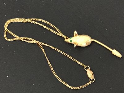 Sale Photo Thumbnail #129: Vintage gold-tone chain necklace featuring a textured mouse pendant with green rhinestone eyes and a flexible snake chain tail. The pendant has a brushed finish detail. Includes a fold-over or spring clasp mechanism. Good vintage condition with light, sta