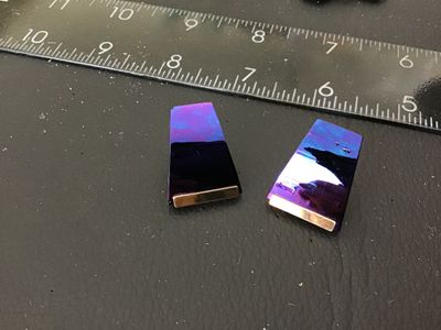 Sale Photo Thumbnail #141: Pair of vintage clip-on earrings featuring a trapezoid shape with an iridescent purple/blue finish and gold-tone bar accents. Gold-tone clip-on hardware on the reverse. Measurements are approximately 1 inch in length as shown against the ruler. Showing mi