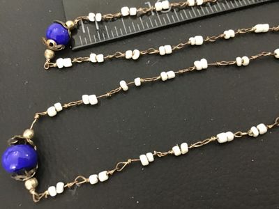 Sale Photo Thumbnail #13: Long vintage wire-wrapped beaded strand necklace featuring cobalt blue glass accent beads with filigree caps and white seed beads linked together with metal wire. Measures over 24 inches total length when doubled/extended as shown against the ruler. Showi