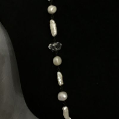 Sale Photo Thumbnail #68: A long station-style strand necklace featuring an alternating arrangement of baroque freshwater pearls, stick pearls, and faceted clear crystal beads connected by dark wire wrapping. Interspersed with textured open-work metal oval links. Includes a lobste