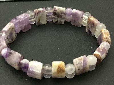 Sale Photo Thumbnail #109: Natural gemstone stretch bracelet featuring polished rectangular/cylindrical purple chevron amethyst beads alternating with round accent beads. Features natural variations, veining, and matrix throughout the stones. Elastic band allows for easy wear. In g