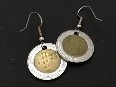 Sale Photo Thumbnail #112: Pair of drop wire earrings crafted from 1993 Mexican 1 Nuevo Peso (N$) bi-metallic coins featuring the Mexican coat of arms and Aztec calendar details. Metal french hook ear wires. Light wear and patina consistent with age and coin circulation.