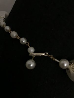 Sale Photo Thumbnail #152: Vintage single-strand choker style statement necklace featuring large baroque-style faux pearl beads alternating with gray and white swirled resin/plastic beads, accented with filigree end caps. Features a J-hook clasp stamped 'JAPAN' with an adjustable p