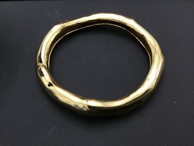 Sale Photo Thumbnail #153: Alexis Bittar gold-tone designer bangle bracelet featuring an organic, undulating sculptural design. Stamped with the Alexis Bittar maker's mark on the interior.   Excellent Condition