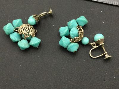 Sale Photo Thumbnail #178: Pair of vintage screw-back dangle earrings featuring bright turquoise blue molded plastic or glass beads cluster-suspended from filigree metal caps. Shows light age-appropriate patina to the metal hardware.