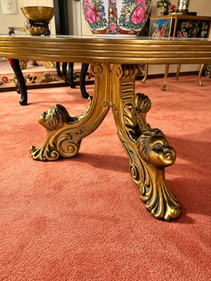 Sale Photo Thumbnail #14: Vintage Hollywood Regency style gilt dining table featuring an ornate tripod pedestal base with sculpted cherub face feet.