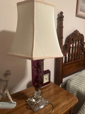 Sale Photo Thumbnail #43: Vintage table lamp featuring a purple hand-blown glass column with painted floral details on a clear molded glass base, topped with a square fabric shade.
