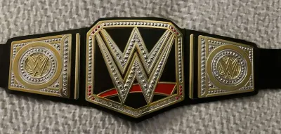 WWE World Heavyweight Championship replica belt featuring gold and silver-toned plates with faux diamond embellishments on a black strap.