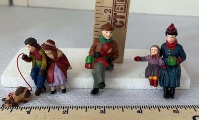 Dept 56 christmas at the park” figures sitting