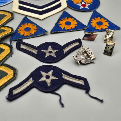 LOT 58L: Collection of Vintage U.S. Military Uniform Insignia, Featuring Chevron, Unit Patches, and Pins