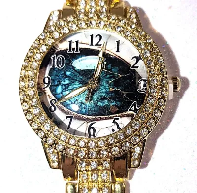 Sale Photo Thumbnail #182: Gold Colored VERY JEWELED BAND + DIAL "Celestial Green" WATCH with BAND: (Gold Tone, Clear Stones Segments 8") DIAL: (1¼" Gold Tone with Jeweled Surround + Round) BATTERY: Button 20 mm  *EXTRA BATTERY INCL.*
ALL ITEMS SHIPPED FREE