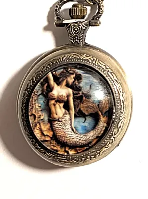 Sale Photo Thumbnail #88: Colorful Exotic MERMAID POCKET WATCH with Black Chain (30" L . Chain/Lobster Clasp) and Gold Tone Case & Setting**EXTRA BATTERY INCLUDED**

Dial: Analog
Opening: Top-Push Knob
ALL ITEMS SHIPPED FREE