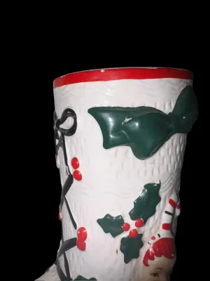 Sale Photo Thumbnail #135: Charming vintage UCAGCO (United China & Glass Company) ceramic Christmas boot planter featuring a whimsical pixie elf dressed in a candy cane-striped outfit, accented with raised holly leaves, berries, and a large green bow. This classic mid-century holid
