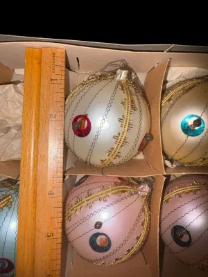 Sale Photo Thumbnail #94: Set of 5 Vintage West Germany Indent Glass Christmas Ornaments
Beautiful set of vintage West Germany glass Christmas ornaments featuring distinctive center indent reflectors, delicate crinkle wire wrapping, gold trim, and jewel-tone reflector accents. Sof