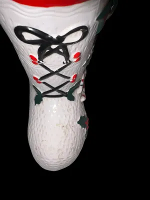Sale Photo Thumbnail #131: Charming vintage UCAGCO (United China & Glass Company) ceramic Christmas boot planter featuring a whimsical pixie elf dressed in a candy cane-striped outfit, accented with raised holly leaves, berries, and a large green bow. This classic mid-century holid