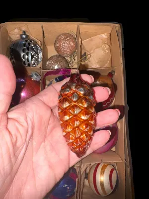 Sale Photo Thumbnail #101: A charming assortment of 13 vintage Christmas ornaments featuring both glass and plastic examples in a variety of classic holiday styles. Includes mercury glass ornaments, an indented reflector ornament, mosaic glass ornaments, a textured pinecone ornamen