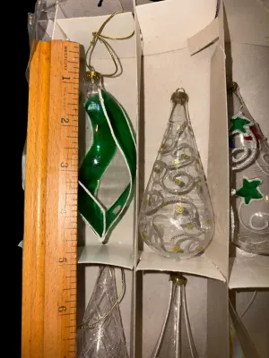 Sale Photo Thumbnail #60: Mixed Lot of Hand-Blown Glass Christmas Ornaments
Beautiful assortment of vintage and newer hand-blown glass Christmas ornaments featuring clear, glittered, swirled, hand-painted, and iridescent Aurora Borealis finishes in a variety of shapes and sizes. I