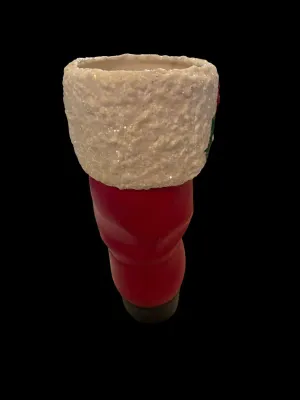 Sale Photo Thumbnail #50: Life-Size Ceramic Santa Boot Planter/Vase
Festive life-size ceramic Santa boot featuring a glittered faux-snow cuff with holly accents. Perfect as a planter, floral arrangement holder, or holiday décor. Measures approximately 8½" tall. Good vintage cond