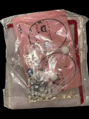 Sale Photo Thumbnail #86: Vintage Edna Looney Original Needle Art Kit featuring a double-sided 6-inch Santa tree ornament. Kit appears unused and includes felt, sequins, beads, trims, plastic snowflake, and instructions in the original packaging. Packaging shows light wear from ag