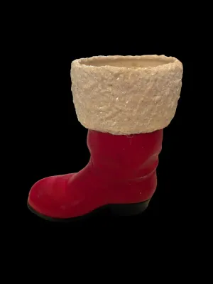 Sale Photo Thumbnail #49: Life-Size Ceramic Santa Boot Planter/Vase
Festive life-size ceramic Santa boot featuring a glittered faux-snow cuff with holly accents. Perfect as a planter, floral arrangement holder, or holiday décor. Measures approximately 8½" tall. Good vintage cond