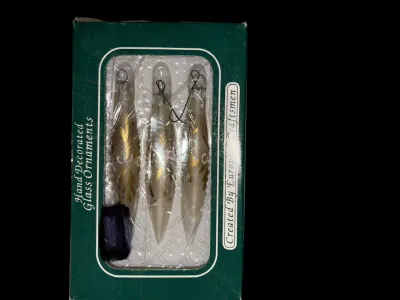 Sale Photo Thumbnail #74: Boxed Set of 3 European Hand-Decorated Glass Finial Ornaments
Elegant set of three hand-decorated glass finial ornaments featuring a frosted pearl finish with hand-painted gold accents. Original box is marked "Hand Decorated Glass Ornaments – Created by