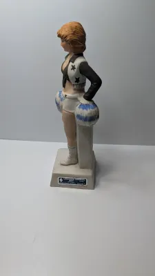 Sale Photo Thumbnail #254: Missing the cork on the bottom

The Vintage 1978 Hoffman Dallas Cowboys Cheerleader Whiskey Decanter is a collectible porcelain liquor bottle manufactured by the Hoffman Distilling Company. Resembling the iconic Dallas Cowboys cheerleaders in their classi