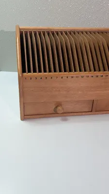 Sale Photo Thumbnail #458: A vintage wooden bill organizer with 31 slots and 2 drawers is a highly practical desktop mail sorter designed to track monthly expenses and correspondence. The 31 vertical slots represent each day of the month, allowing you to file bills, receipts, or re