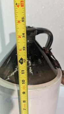 Sale Photo Thumbnail #505: It shows beautiful glaze variations and minor firing irregularities consistent with its age.  The bottom of the jug does have a chip.  

two-tone stoneware moonshine jugs are highly collectible pieces of late 19th- and early 20th-century Americana, origin