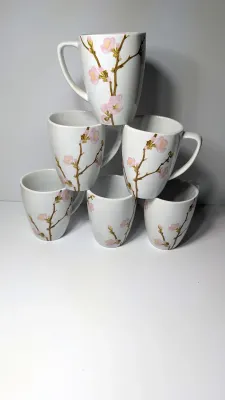 Sale Photo Thumbnail #324: Corelle Cherry Blossom Mugs are a popular discontinued dinnerware line prized for their elegant square silhouette and delicate pink and white floral motif. Unlike Corelle's signature Vitrelle glass plates, these coordinating mugs are crafted from durable,