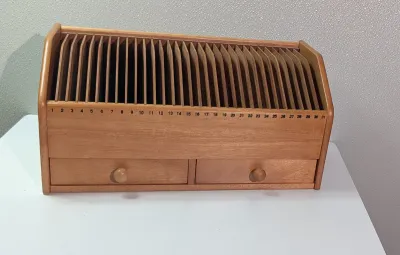 Sale Photo Thumbnail #457: A vintage wooden bill organizer with 31 slots and 2 drawers is a highly practical desktop mail sorter designed to track monthly expenses and correspondence. The 31 vertical slots represent each day of the month, allowing you to file bills, receipts, or re