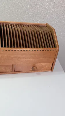 Sale Photo Thumbnail #459: A vintage wooden bill organizer with 31 slots and 2 drawers is a highly practical desktop mail sorter designed to track monthly expenses and correspondence. The 31 vertical slots represent each day of the month, allowing you to file bills, receipts, or re