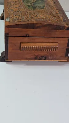 Sale Photo Thumbnail #445: The cedar box with the flower design has a broken latch

Vintage hand-carved cedar jewelry boxes featuring dovetail joints are highly sought-after mid-century collectibles, valued for their aromatic qualities, durability, and distinct folk-art aesthetic. 