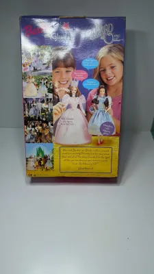 Sale Photo Thumbnail #363: A highly popular playline doll. When you raise her arm, she plays a "brrinnng" magic wand sound effect or says, "Tap your heels together three times". She features strawberry-blonde hair and a pink satin gown with star and butterfly accents