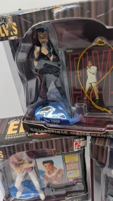 Sale Photo Thumbnail #223: Boxes have damage 

Nostalgic 4-inch pieces frequently feature Elvis in his iconic Aloha shirt strumming a ukulele,


4-inch figure produced by Trevco in 2002. It features Elvis in his iconic black leather outfit from the famous '68 Comeback SpecialThe El