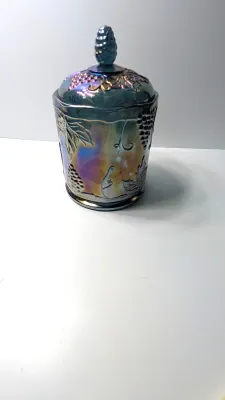Sale Photo Thumbnail #271: This item is an original "Harvest Grape" (or simply "Harvest") pattern covered canister manufactured by the Indiana Glass Company.

Distinctive embossed clusters of grapes and large leaves, complete with a matching lid and textured finial.the pattern was 