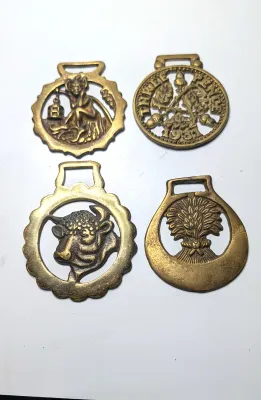 Sale Photo Thumbnail #315: Horse brass bridal medallions (or "horse brasses") are decorative, solid-brass plaques originally used to embellish the bridles and harnesses of working and parade horses. Originating in England in the mid-19th century, carters and farmers first used them