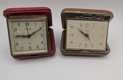 Sale Photo Thumbnail #402: Clocks are untested - The Elgin face cover has come off

Bradley and Elgin are classic mid-20th-century folding travel and desk alarm clocks manufactured in (West) Germany, typically featuring mechanical wind-up, 1-jewel movements. Often utilized by vario