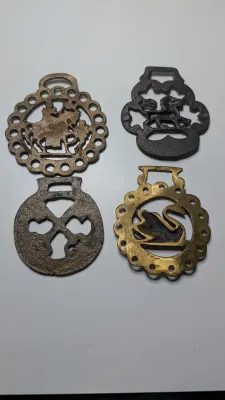 Sale Photo Thumbnail #310: Horse brass bridal medallions (or "horse brasses") are decorative, solid-brass plaques originally used to embellish the bridles and harnesses of working and parade horses. Originating in England in the mid-19th century, carters and farmers first used them