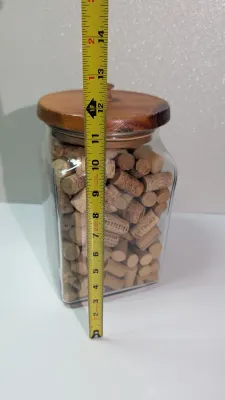 Sale Photo Thumbnail #455: Collecting wine and champagne corks in a decorative jar is a popular and rustic way to display mementos from celebrations and tastings. Because champagne corks are larger and mushroom-shaped, alternating them with standard wine corks adds great visual tex