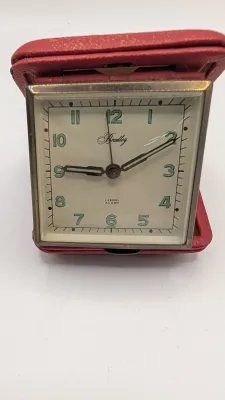 Sale Photo Thumbnail #406: Clocks are untested - The Elgin face cover has come off

Bradley and Elgin are classic mid-20th-century folding travel and desk alarm clocks manufactured in (West) Germany, typically featuring mechanical wind-up, 1-jewel movements. Often utilized by vario